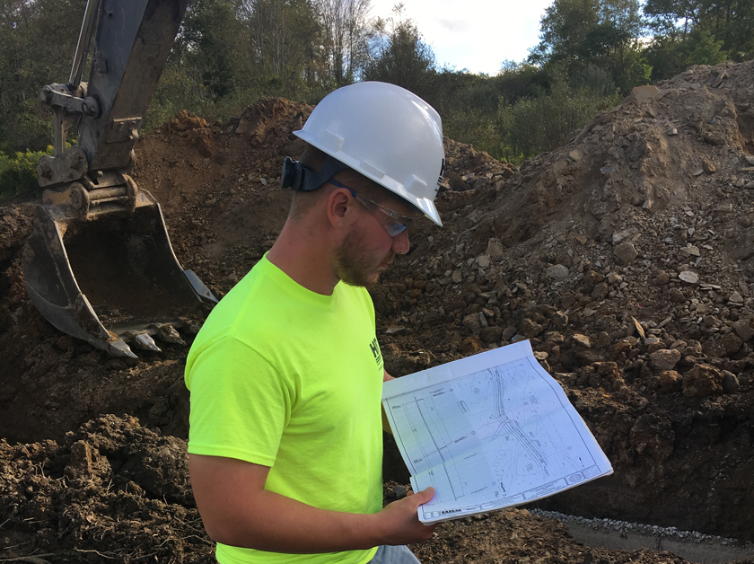 Ethan Williams observes construction of a sewer system