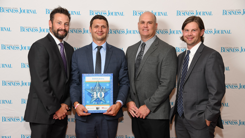 Jason Fralick, Ed Ellinger, and Matt Bonanno Celebrate with Forty Under 40 honoree Justin Mendinsky