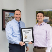 Justin Mendinsky presents the ENR Top Young Professionals plaque to Josh Fox