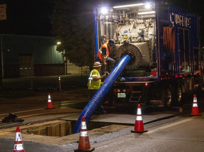 Pipeline rehabilitation crews working at night