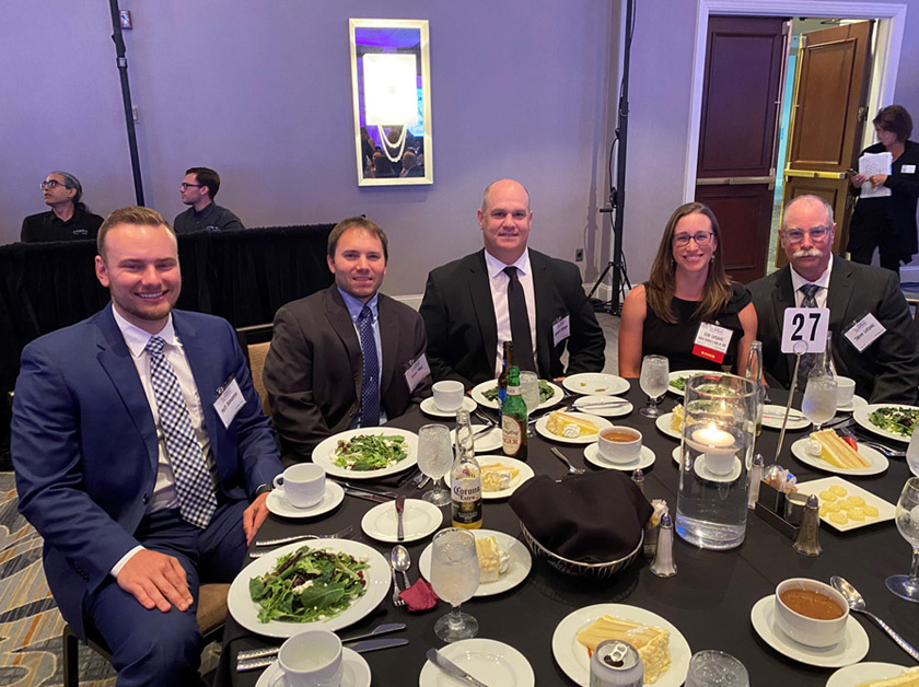 Jordan Baker, Jason Hinz, and Ed Ellinger celebrate with Erin Letavic and her husband at the Women of Influence ceremony