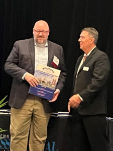 Chris Dellinger accepts an award for his leadership in the construction and real estate industry from Ernest Long, editor of the Central Penn Business Journal