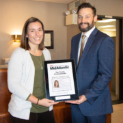 Erin Threet receives a plaque from company president Jason Fralick