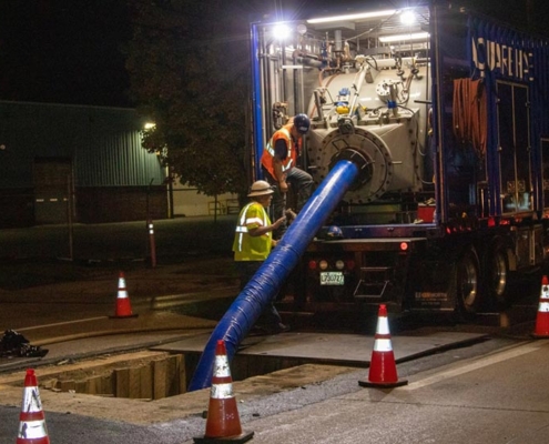 Pipeline rehabilitation crews working at night