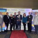 The HRG team holds their award on the red carpet at the Best Places to Work in PA ceremony on December 12, 2024.