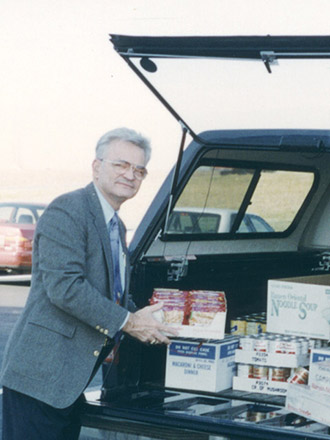 HRG founder Bob Rowland loads donations to the local food pantry into his car for delivery