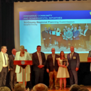 Erin Letavic joins the team accepting its award for the Dauphin County Water Resources Enhancement Program on stage.