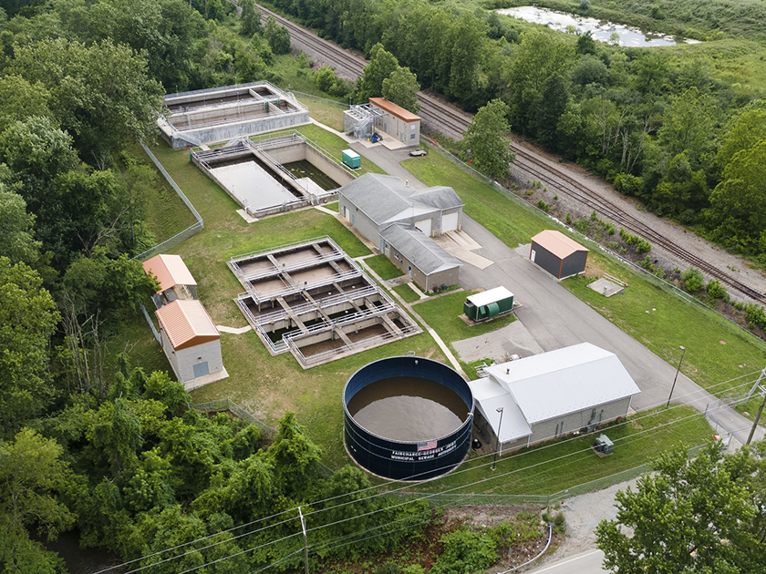 aerial photo of a wastewater treatment plant surrounded by trees