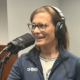 Melissa Rohland smiles and talks into a microphone as she records a podcast on smart water technology and digital twins